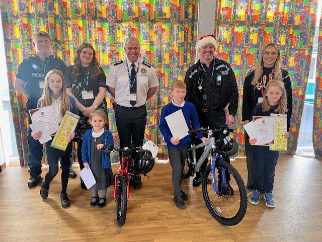 bike winner all winners (Left to right ) – Deputy Commander Joe Postlethwaite, Lily Manley, Molly Neeson, Nina Muceli, Jon Guest (District Manager, Leicestershire Fire & Rescue Service), Harley Andrew, Inspector Steve Burge (Coalville NPA Commander), Sophie Green, Miss. Farrar.